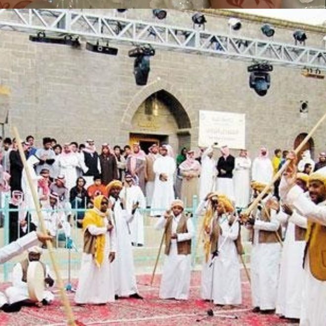 رجال يؤدون رقصة المزمار الحجازية بالعصي والطبول في عرس
سعودي تقليدي أمام الحضور